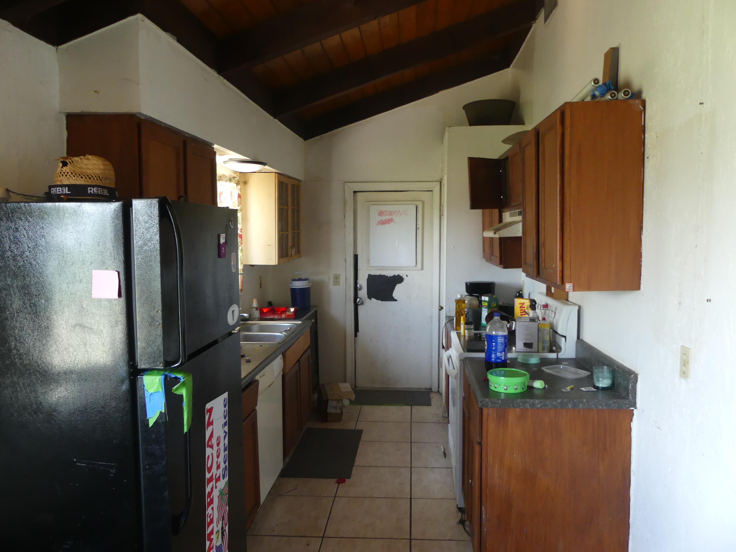 6633 Rigger Road Lake Worth, FL 33462 - Photo 13 of 28 a kitchen with refrigerator and mirror