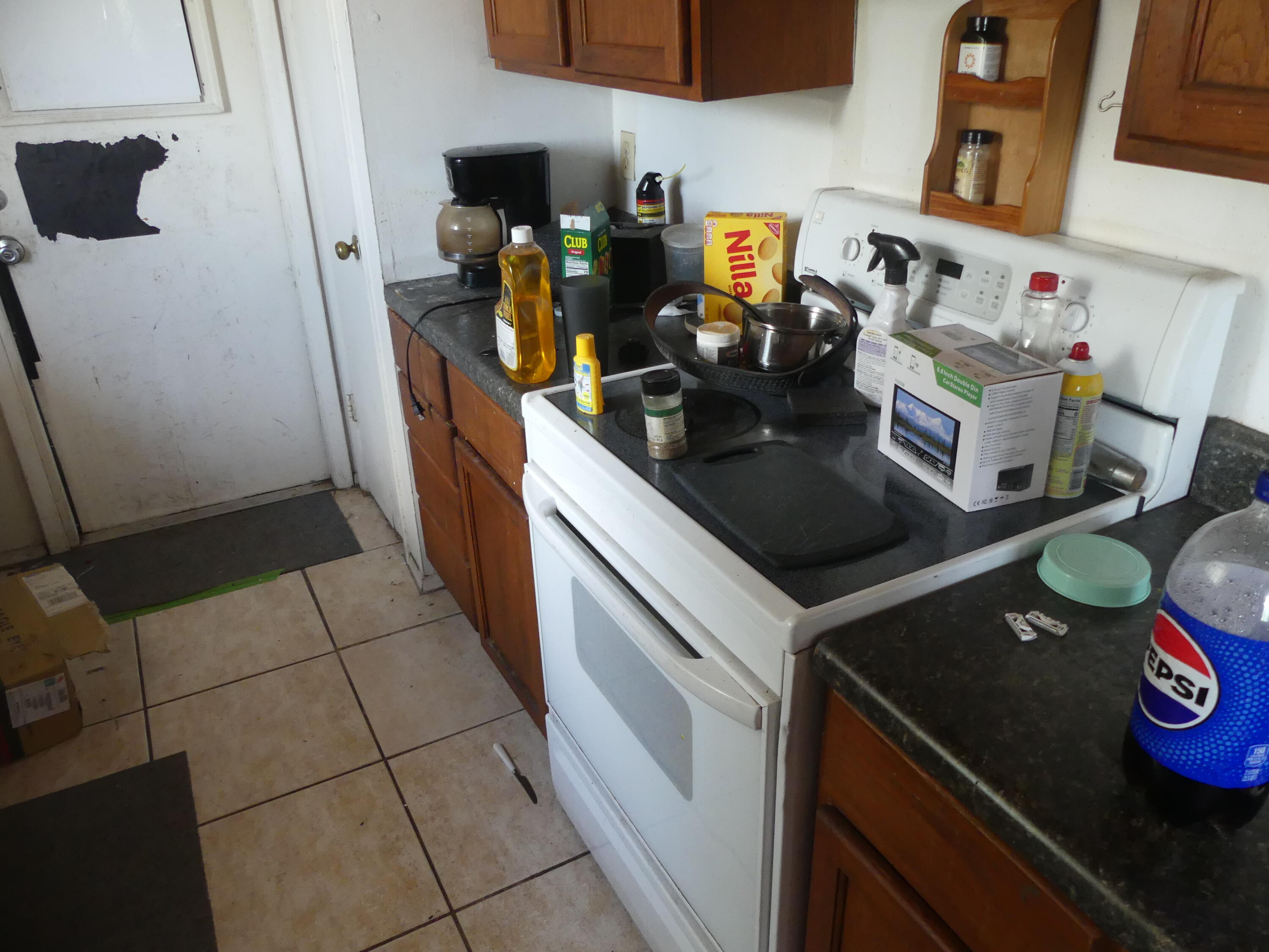 6633 Rigger Road Lake Worth, FL 33462 - Photo 17 of 28 a kitchen with a sink and a stove top oven