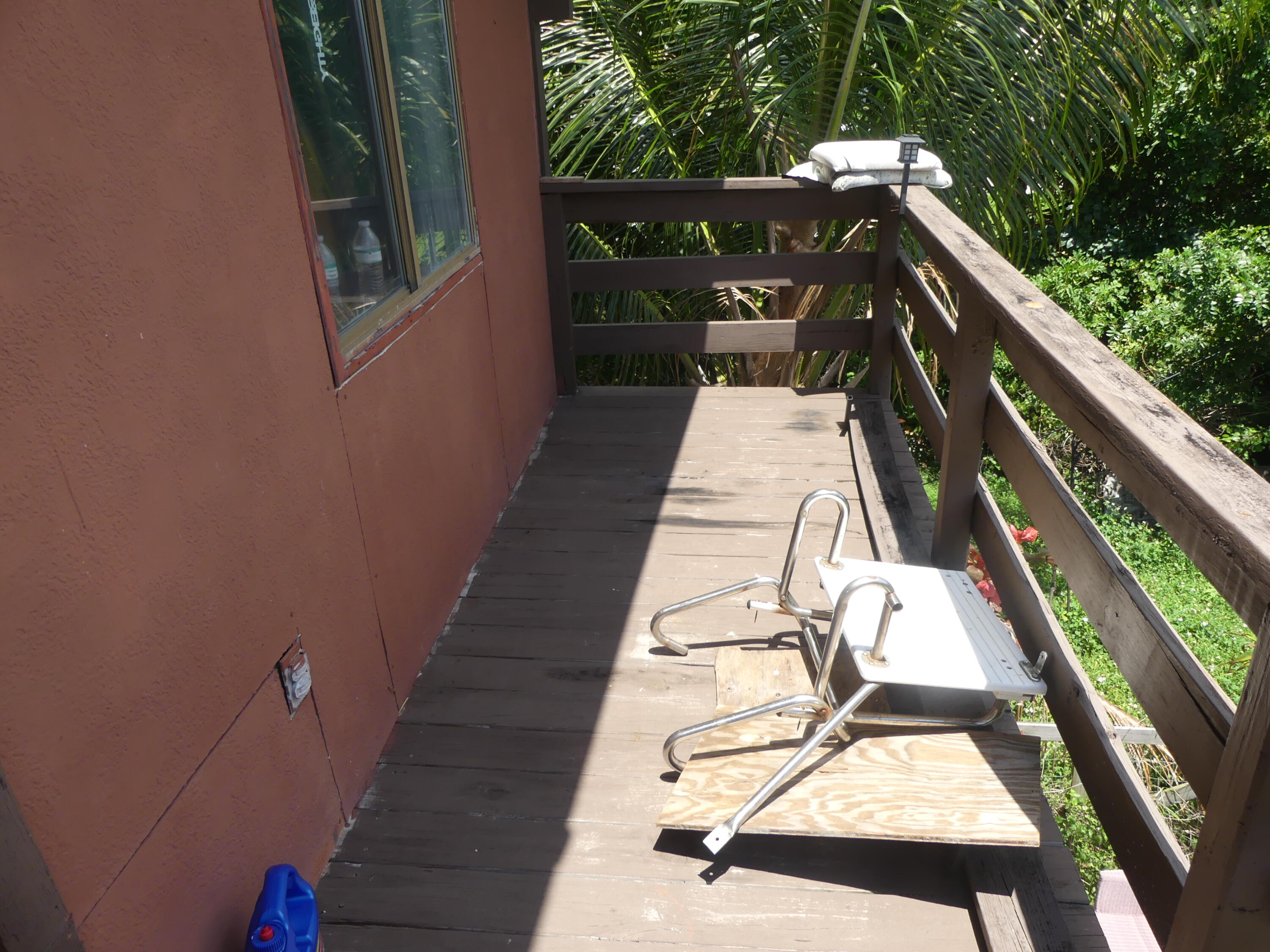 6633 Rigger Road Lake Worth, FL 33462 - Photo 18 of 28 a view of balcony with wooden floor and outdoor seating