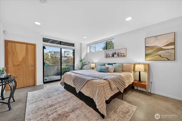 a bedroom with a large bed and a large window
