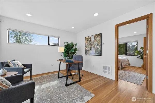 a living room with furniture and a potted plant