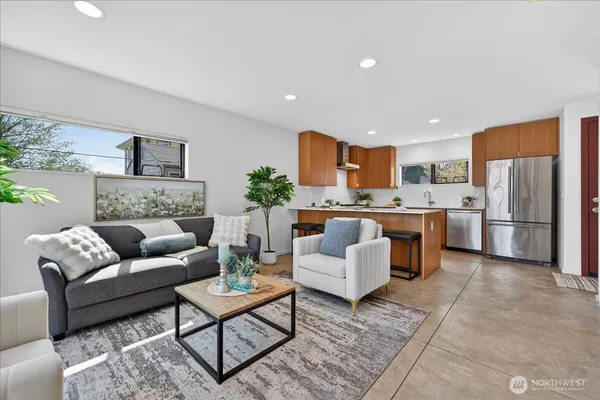 a living room with furniture and kitchen view