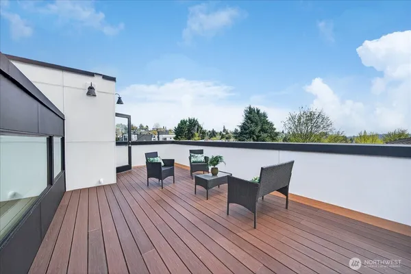 a roof deck view with table and chairs
