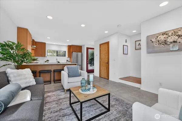 a living room with furniture and a dining table with kitchen view