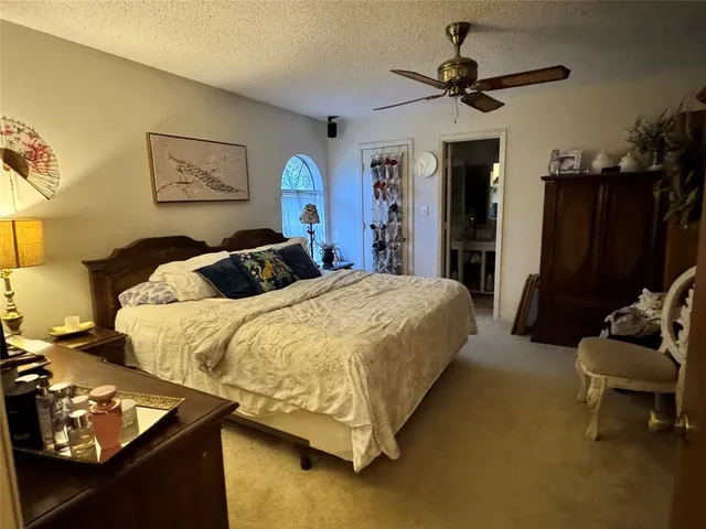 a bedroom with bed and a chandelier