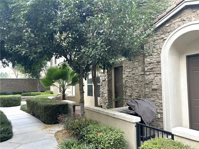 a view of a patio with table and chairs and a large tree