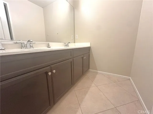 a bathroom with a double vanity sink and mirror