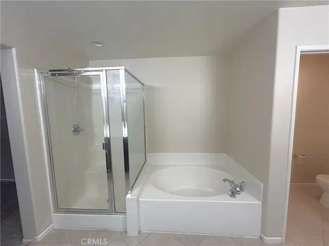a bathroom with a tub and shower