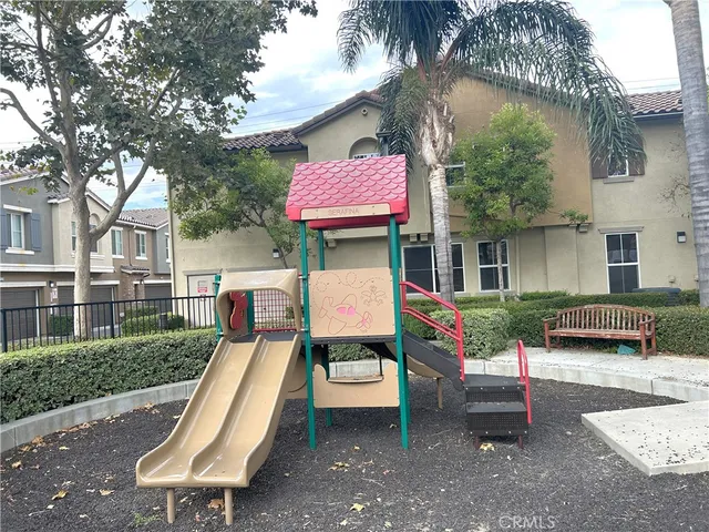a view of a patio with a table chairs and a fire pit
