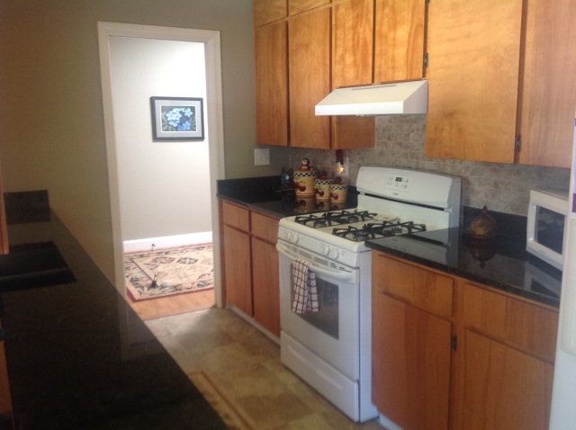 1868 Upper River Road Macon, GA 31211 - Photo 12 of 33 a kitchen with granite countertop a stove and a sink