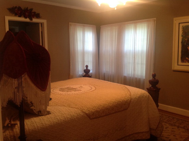 1868 Upper River Road Macon, GA 31211 - Photo 18 of 33 a bed sitting in a bedroom next to a window and a mirror