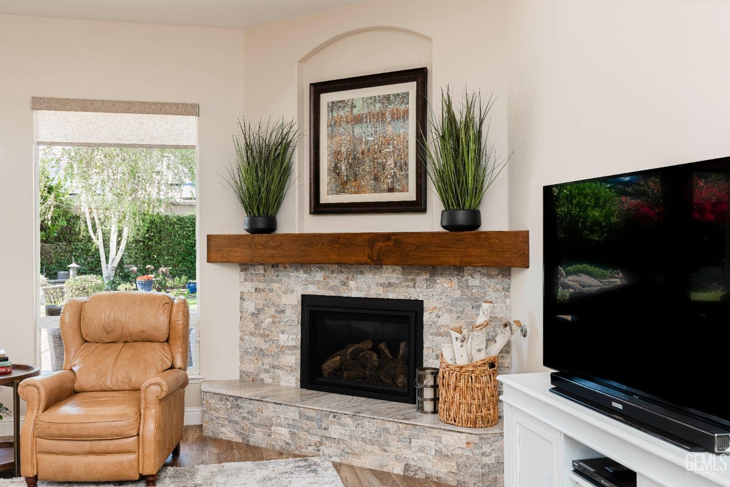 Undisclosed Address Bakersfield, CA 93312 - Photo 15 of 51 a living room with furniture a flat screen tv and a fireplace
