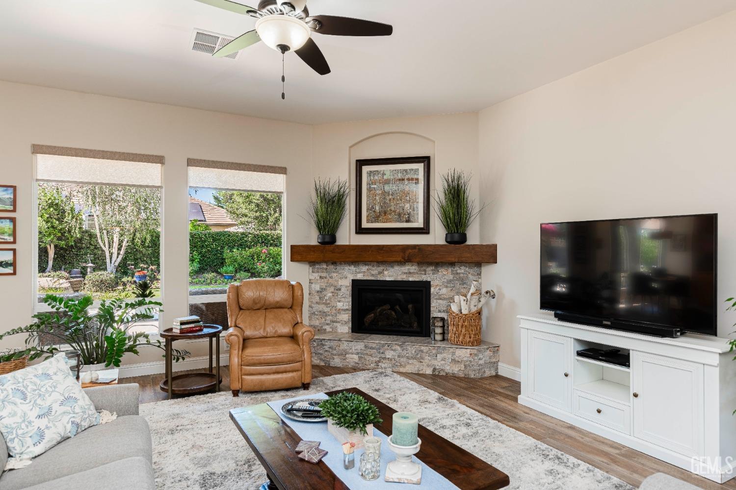Undisclosed Address Bakersfield, CA 93312 - Photo 17 of 51 a living room with furniture a flat screen tv and a fireplace
