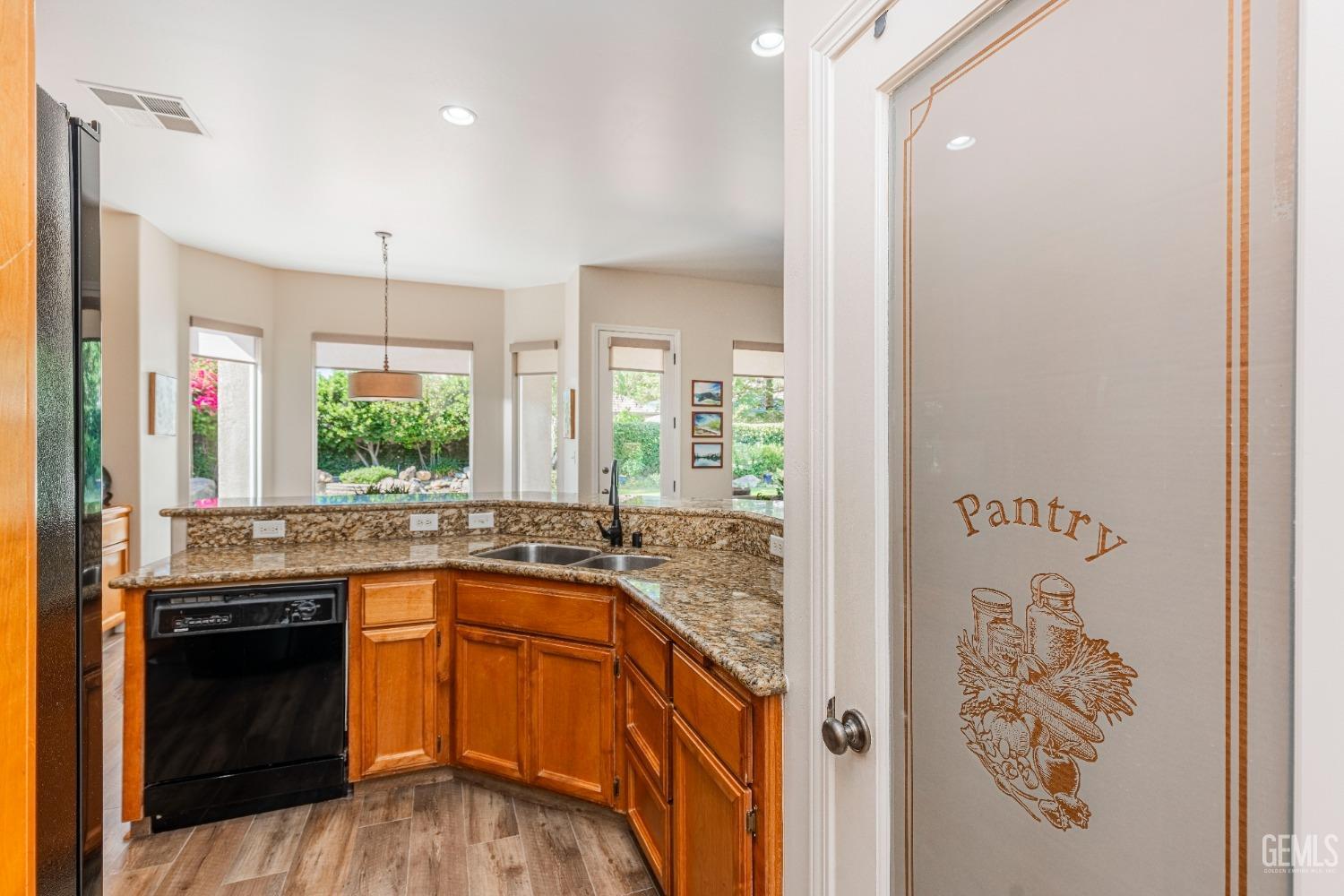 Undisclosed Address Bakersfield, CA 93312 - Photo 25 of 51 a kitchen with a sink stove and cabinets