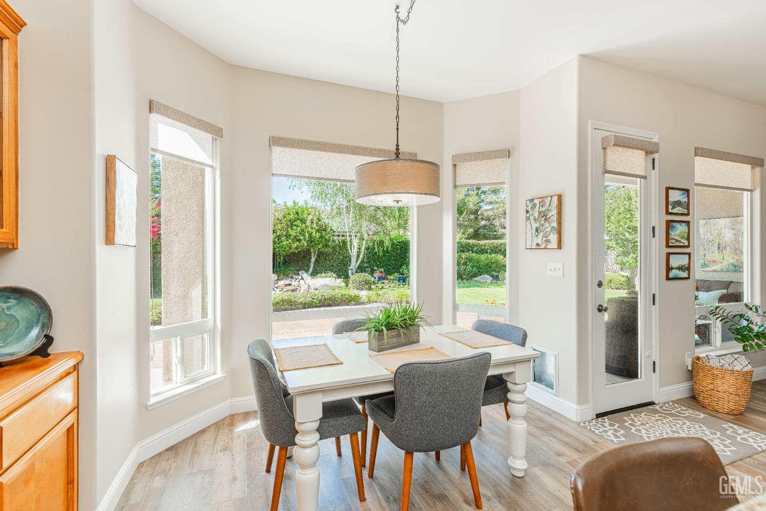 Undisclosed Address Bakersfield, CA 93312 - Photo 29 of 51 a dining room with furniture a chandelier and wooden floor