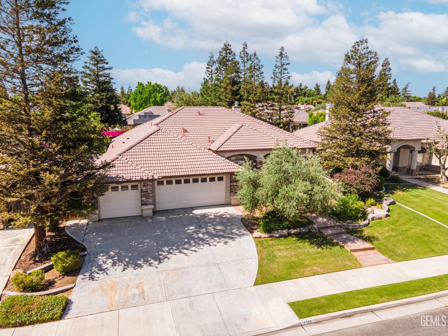 Undisclosed Address Bakersfield, CA 93312 - Photo 3 of 51 a view of a house with a yard and potted plants
