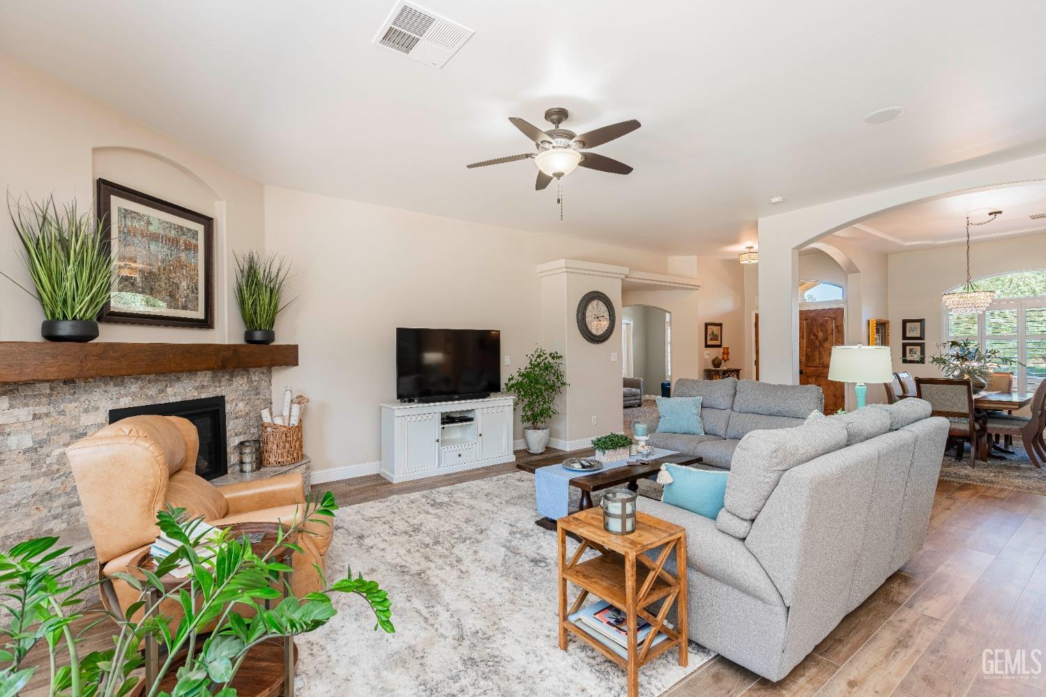 Undisclosed Address Bakersfield, CA 93312 - Photo 32 of 51 a living room with furniture a flat screen tv and a fireplace