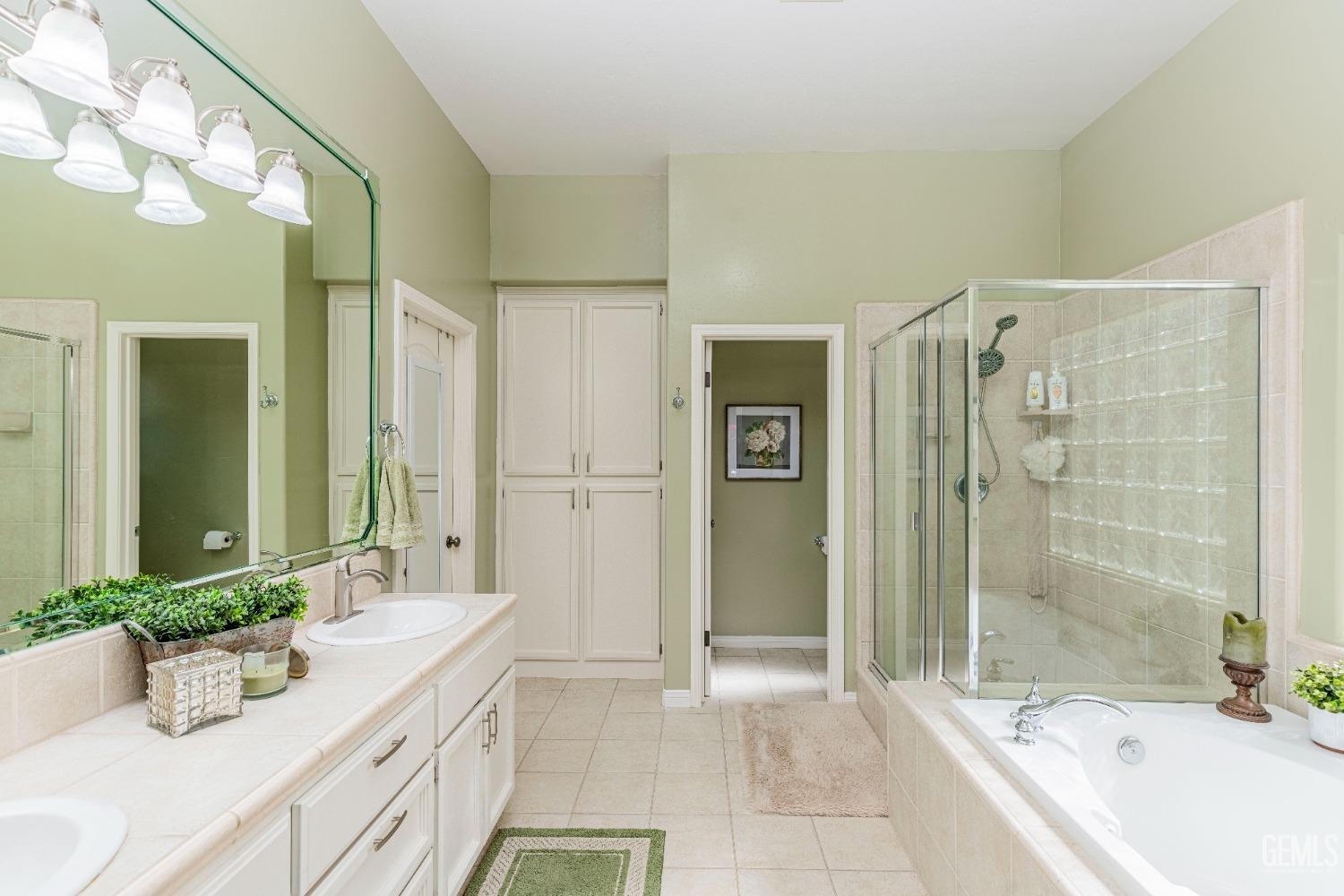 Undisclosed Address Bakersfield, CA 93312 - Photo 36 of 51 a bathroom with a granite countertop tub sink and mirror