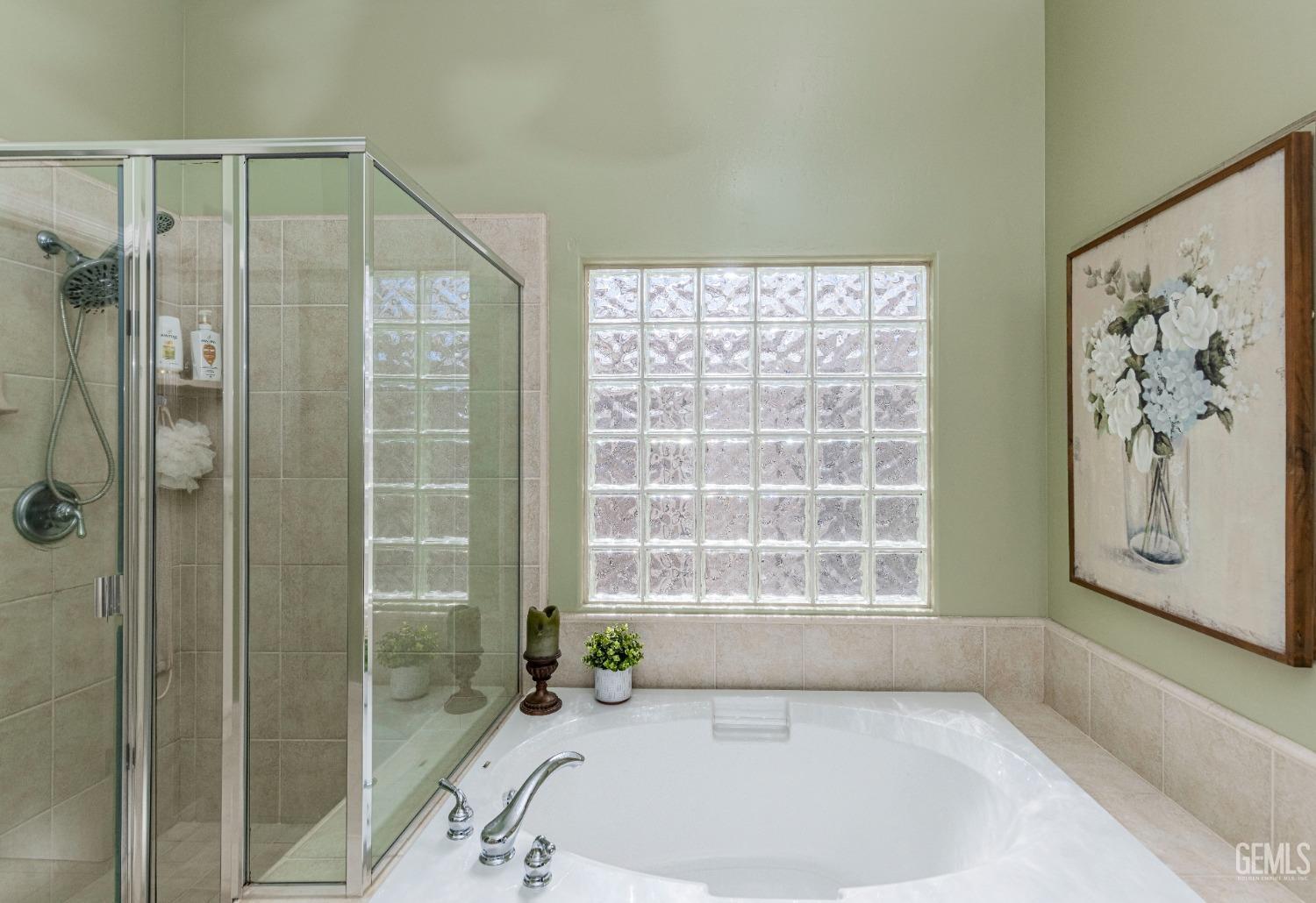 Undisclosed Address Bakersfield, CA 93312 - Photo 39 of 51 a bathroom with a bathtub and a shower