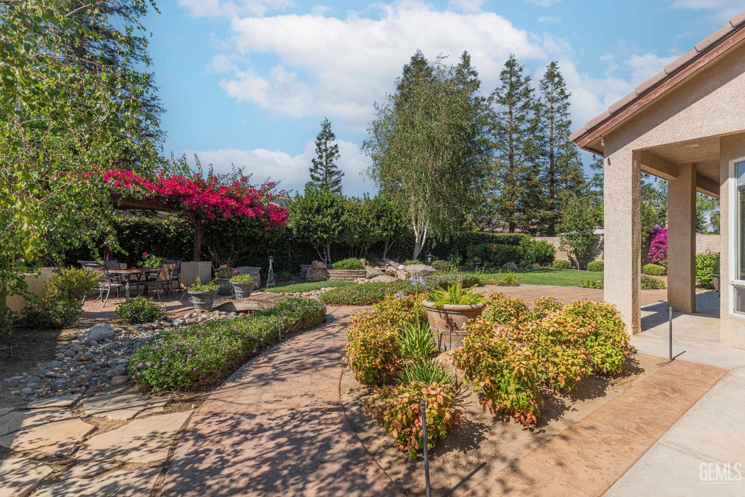 Undisclosed Address Bakersfield, CA 93312 - Photo 42 of 51 a view of a garden with plants and large trees