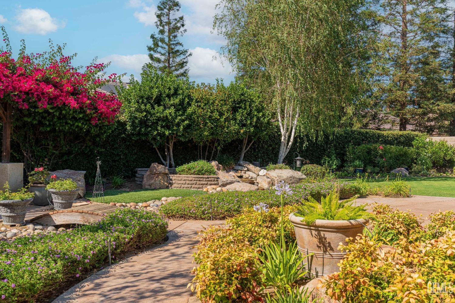 Undisclosed Address Bakersfield, CA 93312 - Photo 43 of 51 a view of a fountain with flower plants