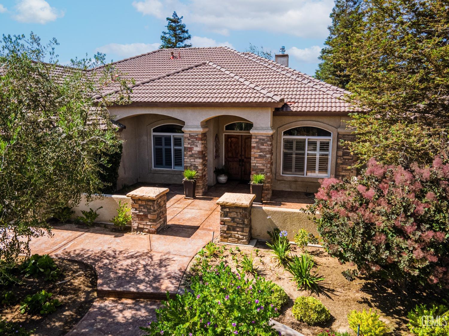 Undisclosed Address Bakersfield, CA 93312 - Photo 6 of 51 a front view of a house with a yard