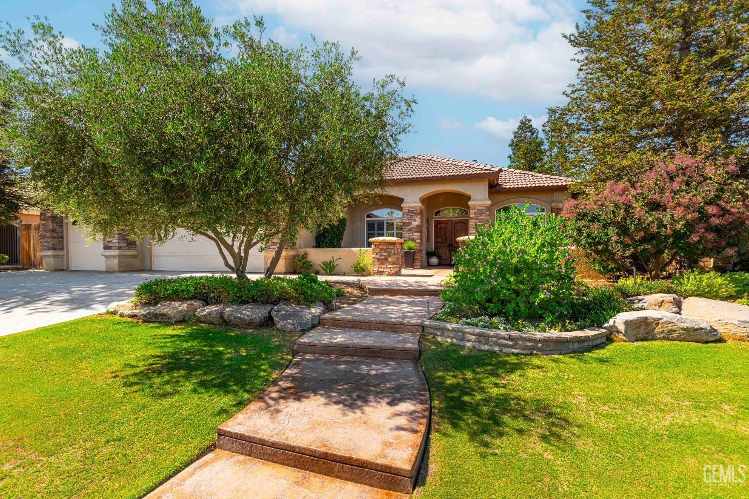 Undisclosed Address Bakersfield, CA 93312 - Photo 9 of 51 a front view of a house with garden