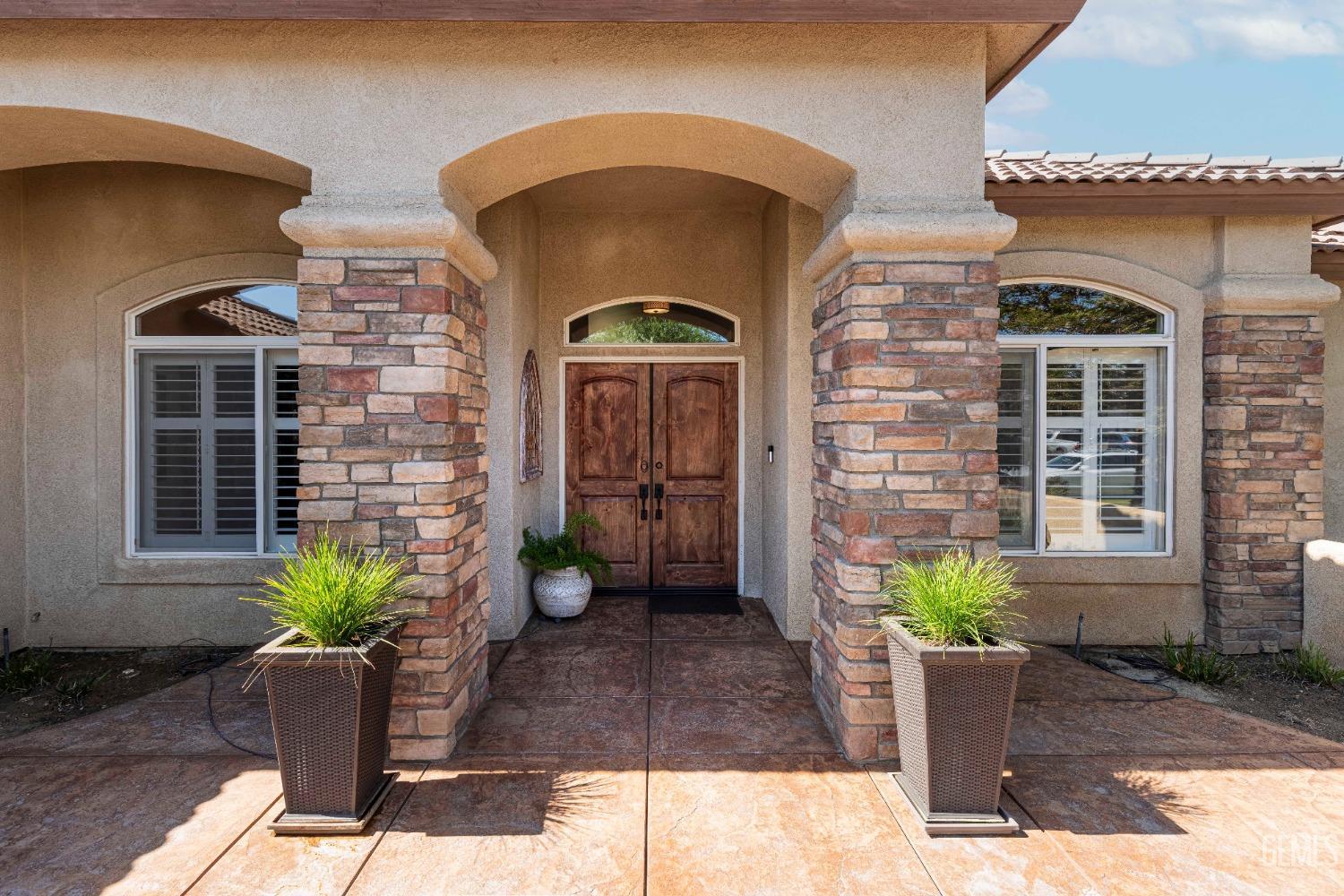 Undisclosed Address Bakersfield, CA 93312 - Photo 10 of 51 a front view of a house with potted plants