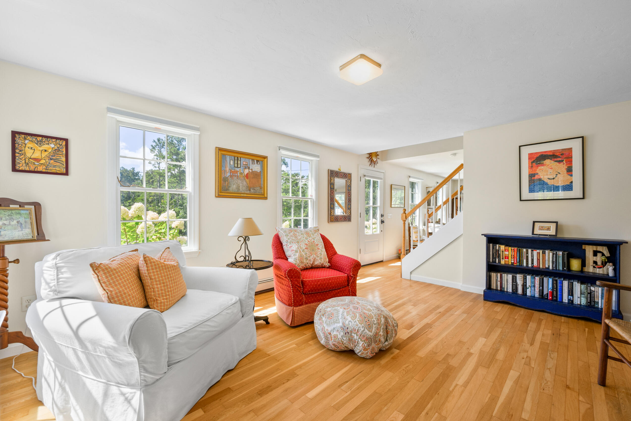 19 Burning Bush Way Brewster, MA 02631 - Photo 14 of 54 a living room with furniture and a book shelf