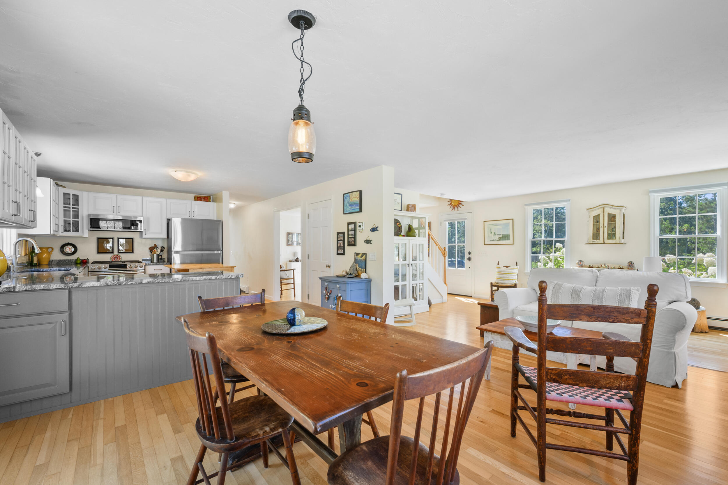 19 Burning Bush Way Brewster, MA 02631 - Photo 6 of 54 a dining room with furniture a chandelier and wooden floor