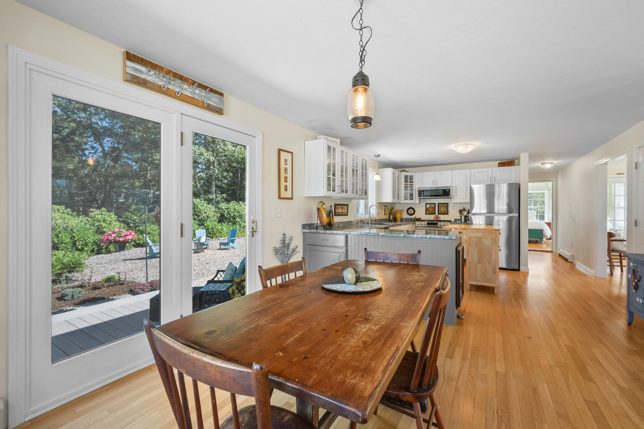 19 Burning Bush Way Brewster, MA 02631 - Photo 7 of 54 a dining room with stainless steel appliances granite countertop a table chairs and a chandelier