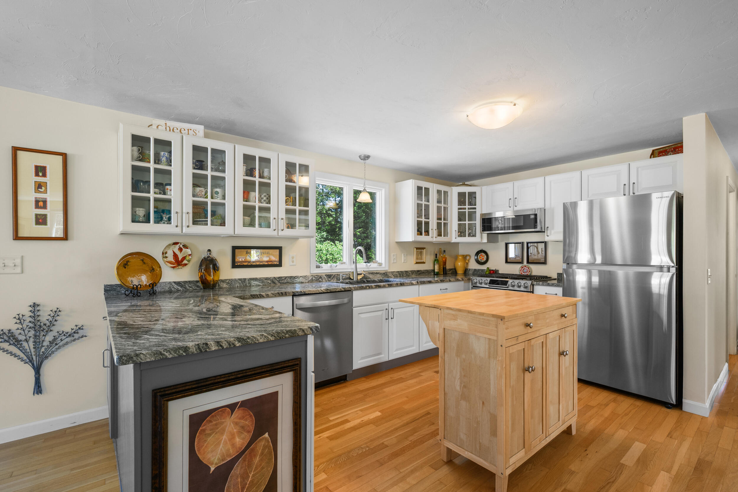 19 Burning Bush Way Brewster, MA 02631 - Photo 8 of 54 a kitchen with stainless steel appliances granite countertop a stove and a refrigerator