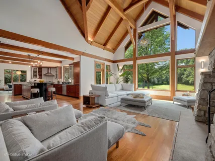 a kitchen with stainless steel appliances kitchen island granite countertop a table chairs and a refrigerator