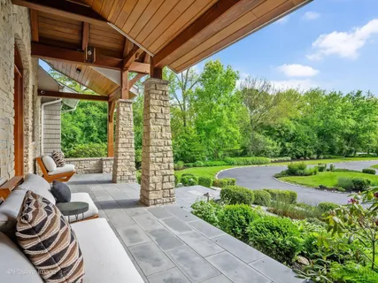 a dining hall with stainless steel appliances granite countertop a stove and a wooden floors