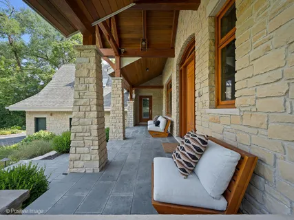 a living room with furniture a fireplace and a floor to ceiling window