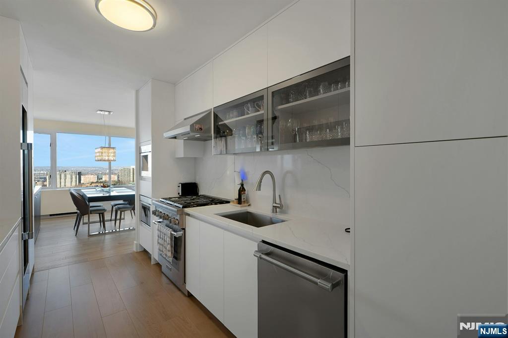 6 Horizon Road, Unit 2602 Fort Lee, NJ 07024 - Photo 15 of 45 a kitchen with stainless steel appliances granite countertop a sink stove and cabinets