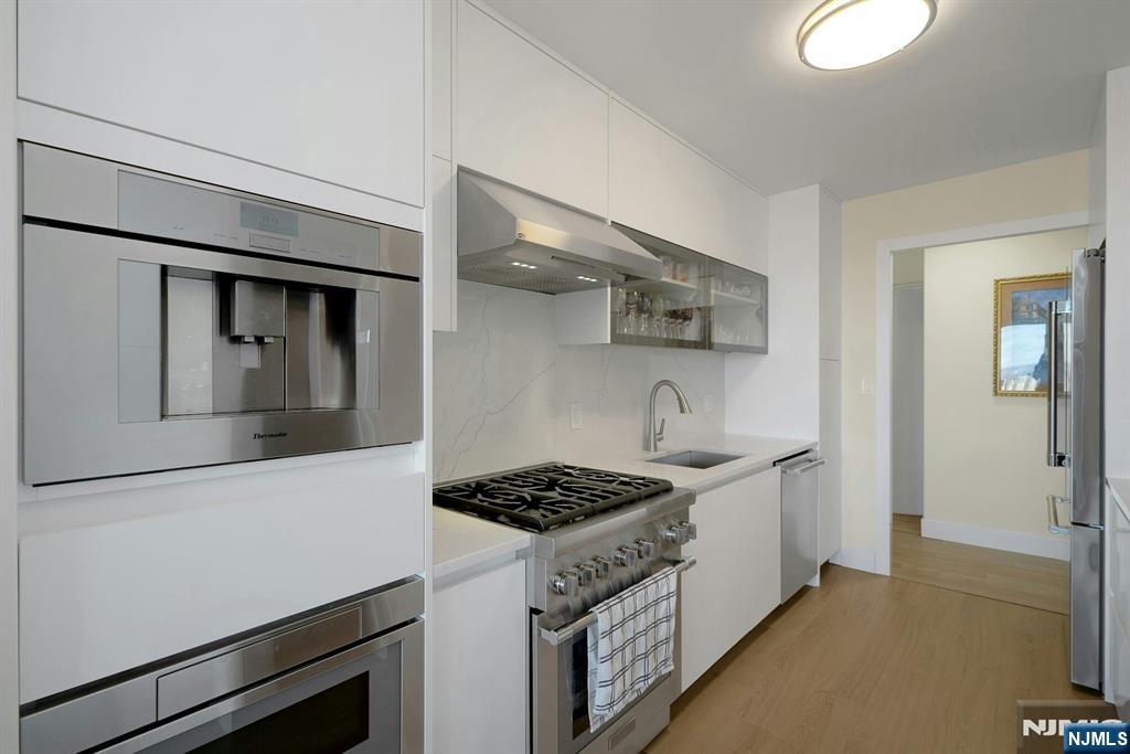 6 Horizon Road, Unit 2602 Fort Lee, NJ 07024 - Photo 18 of 45 a kitchen with stainless steel appliances a sink stove and cabinets