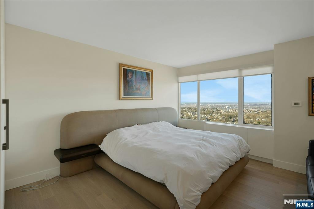 6 Horizon Road, Unit 2602 Fort Lee, NJ 07024 - Photo 20 of 45 a bedroom with a bed and a chair