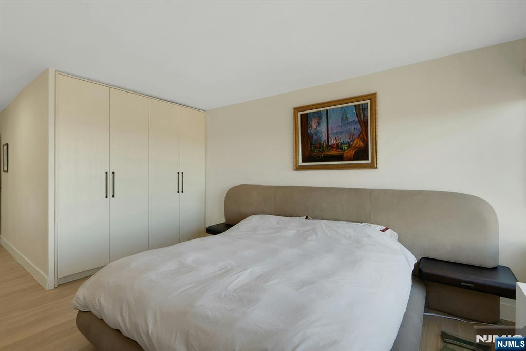 6 Horizon Road, Unit 2602 Fort Lee, NJ 07024 - Photo 21 of 45 a bedroom with a bed and a chair