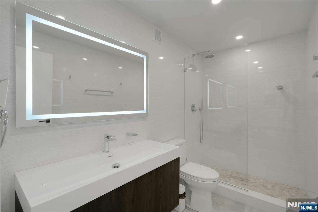 6 Horizon Road, Unit 2602 Fort Lee, NJ 07024 - Photo 23 of 45 a bathroom with a sink a toilet and shower