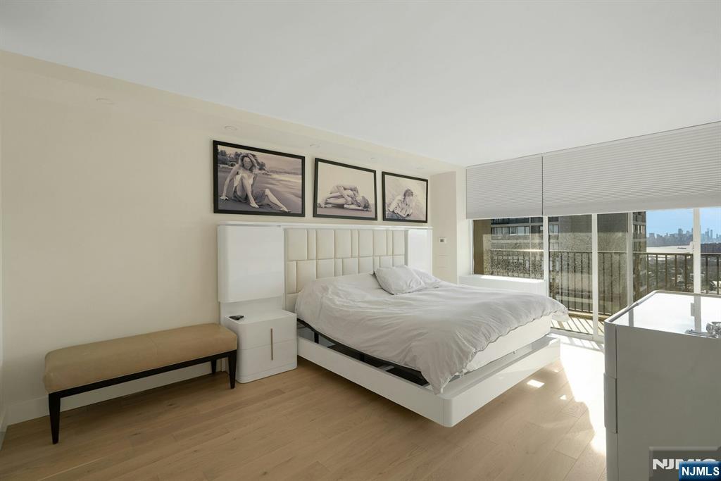 6 Horizon Road, Unit 2602 Fort Lee, NJ 07024 - Photo 28 of 45 a bedroom with a bed and glass door