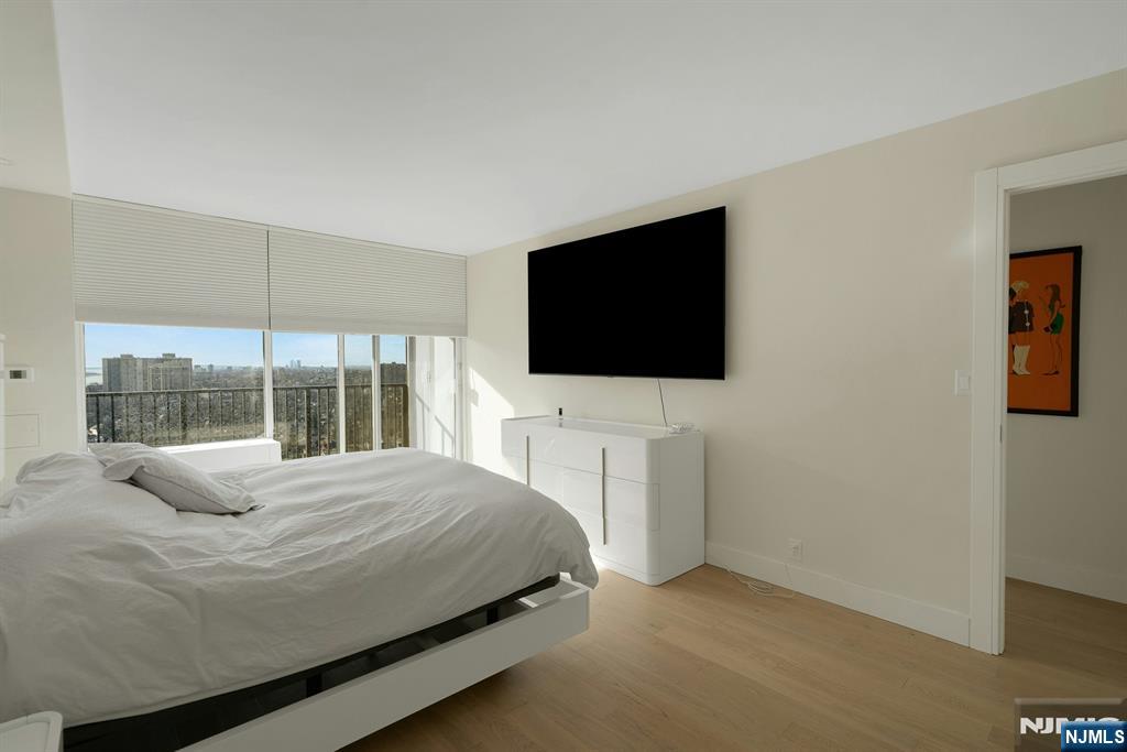 6 Horizon Road, Unit 2602 Fort Lee, NJ 07024 - Photo 29 of 45 a bedroom with a bed tv and a window