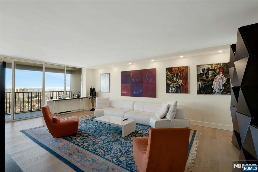 6 Horizon Road, Unit 2602 Fort Lee, NJ 07024 - Photo 7 of 45 a living room with furniture and a rug