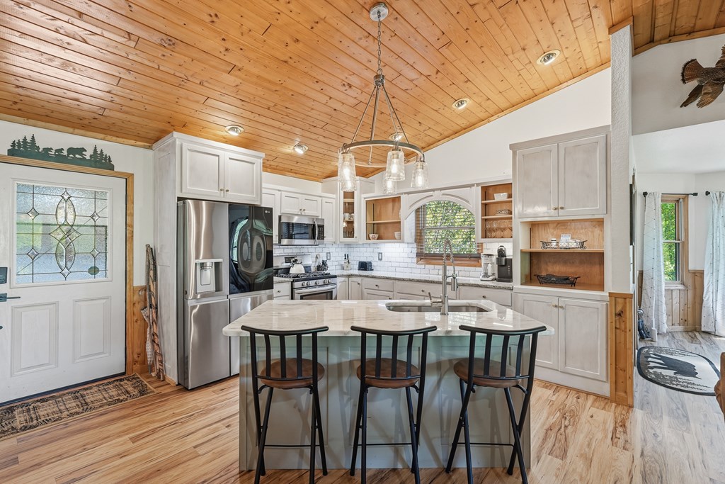 445 Tranquil Cove Road Murphy, NC 28906 - Photo 29 of 91 a kitchen with stainless steel appliances granite countertop a stove a refrigerator a kitchen island a table and chairs