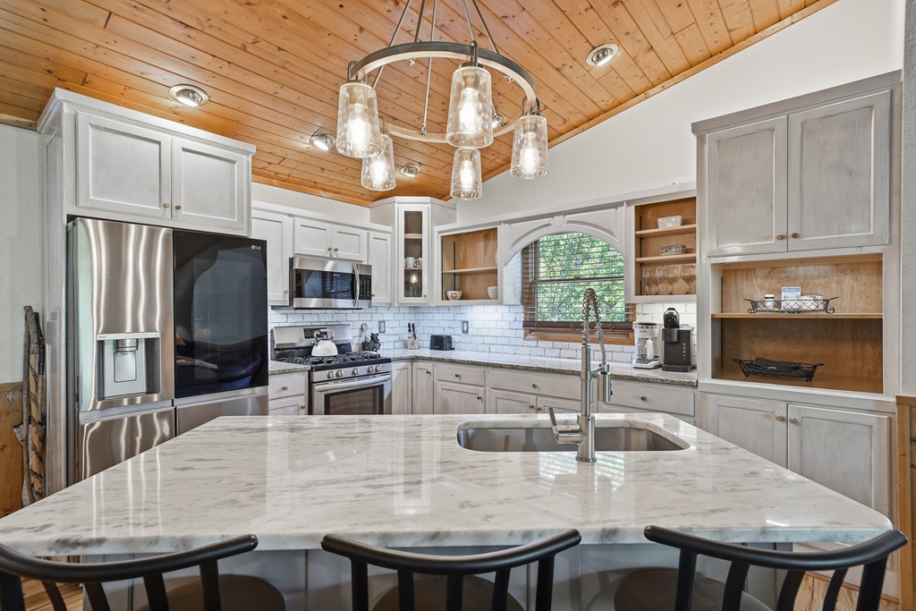 445 Tranquil Cove Road Murphy, NC 28906 - Photo 32 of 91 a kitchen with stainless steel appliances granite countertop a kitchen island a stove a table and chairs