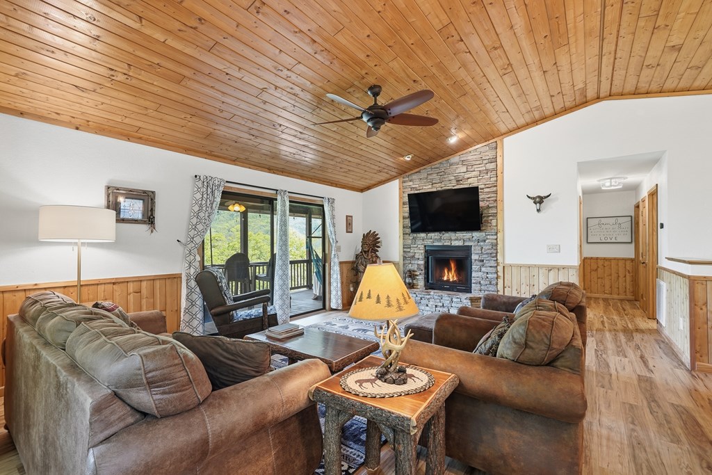 445 Tranquil Cove Road Murphy, NC 28906 - Photo 37 of 91 a living room with furniture a large window and a flat screen tv
