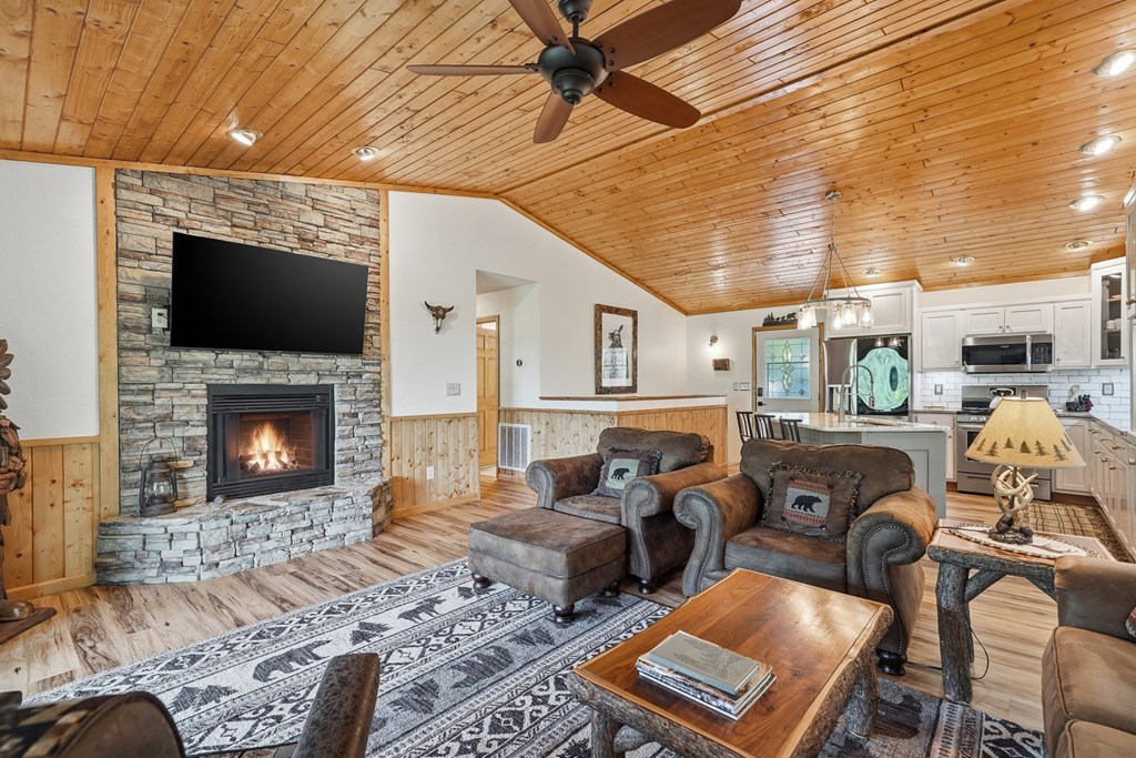 445 Tranquil Cove Road Murphy, NC 28906 - Photo 40 of 91 a living room with furniture a flat screen tv and a fireplace