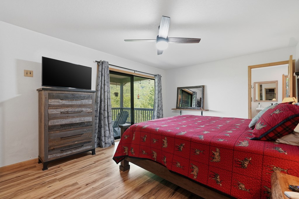 445 Tranquil Cove Road Murphy, NC 28906 - Photo 50 of 91 a bedroom with a bed and a flat screen tv