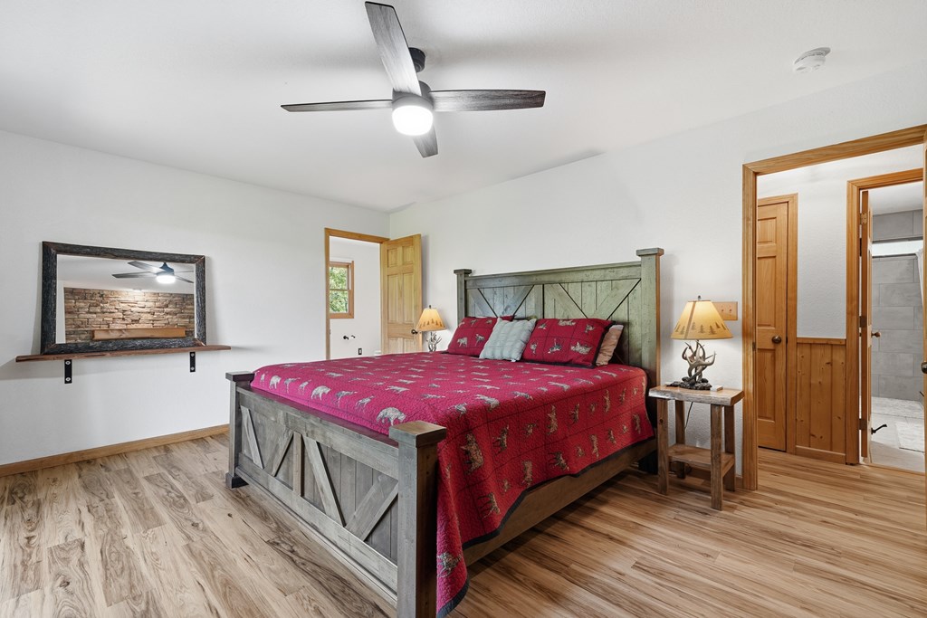 445 Tranquil Cove Road Murphy, NC 28906 - Photo 51 of 91 a bedroom with a bed and a chandelier