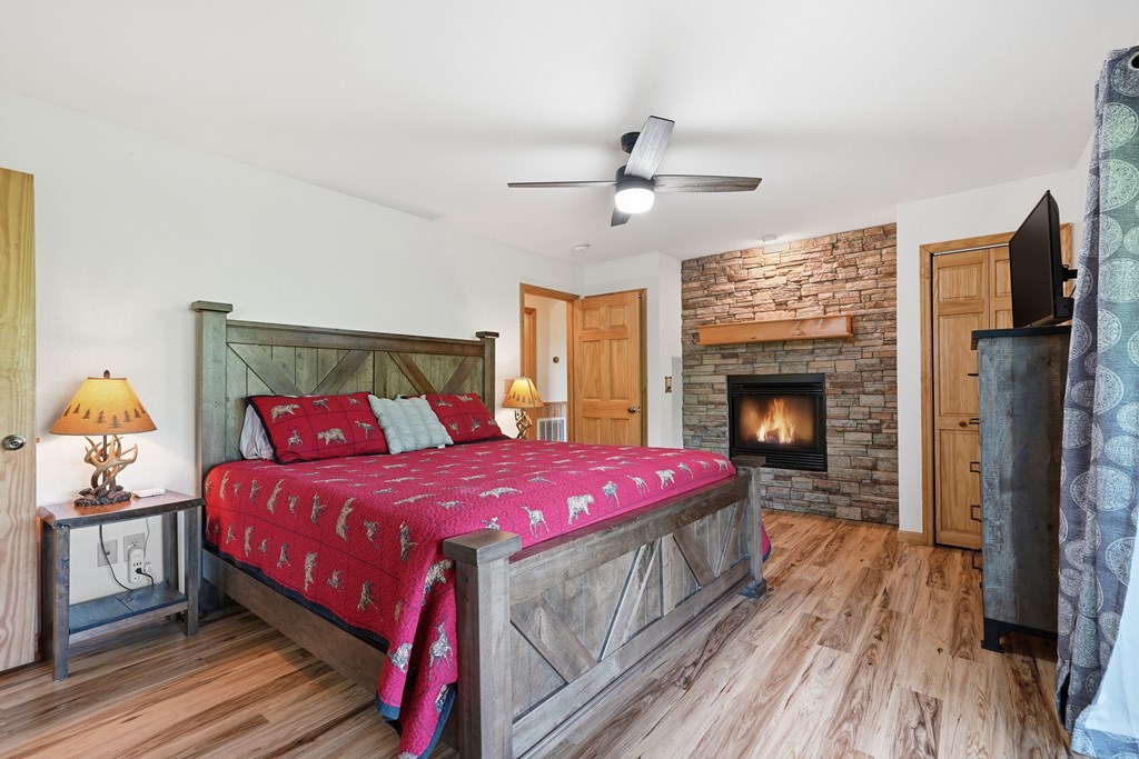 445 Tranquil Cove Road Murphy, NC 28906 - Photo 52 of 91 a bedroom with a bed and a fireplace